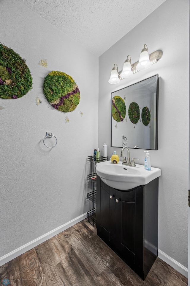 2350 20th Ave S, Fargo, ND 58103 - bathroom with vanity, wood finished floors, and a textured ceiling