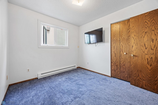2350 20th Ave S, Fargo, ND 58103 - unfurnished bedroom featuring baseboard heating, carpet, a closet, and a textured ceiling