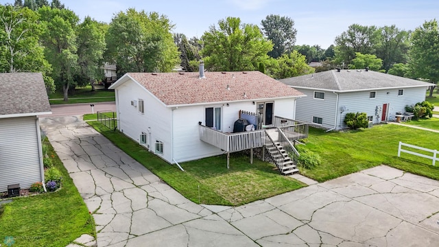 2350 20th Ave S, Fargo, ND 58103 - back of property featuring stairs, a deck, a lawn, driveway, and roof with shingles