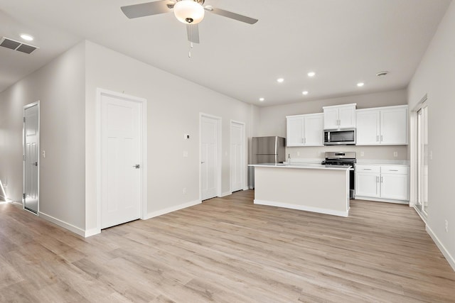 39743 Fallbrook Ave, North Branch, MN 55056 - kitchen featuring stainless steel appliances, light wood-style flooring, recessed lighting, white cabinets, and ceiling fan