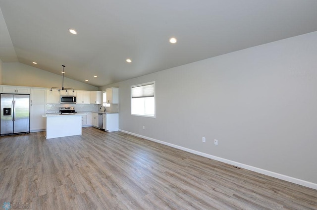 1170 Highland Ln W, West Fargo, ND 58078 - unfurnished living room featuring lofted ceiling, light wood finished floors, and recessed lighting