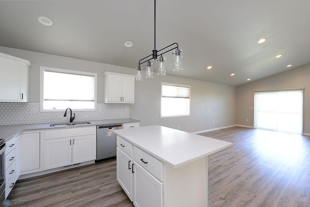 1170 Highland Ln W, West Fargo, ND 58078 - kitchen featuring stainless steel dishwasher, backsplash, light wood-style flooring, white cabinetry, and light countertops