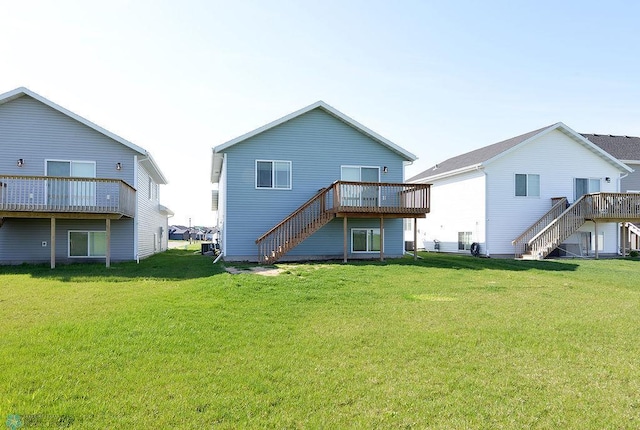 1170 Highland Ln W, West Fargo, ND 58078 - back of house featuring stairway, a lawn, and a wooden deck