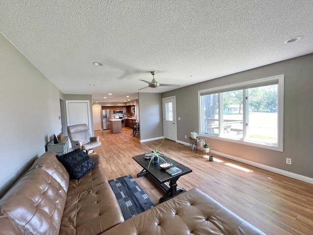 402 Range Rd, Springfield, MN 56087 - living area with light wood-style flooring, a textured ceiling, a ceiling fan, and recessed lighting