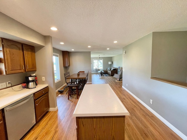 402 Range Rd, Springfield, MN 56087 - kitchen featuring dishwasher, light wood finished floors, a textured ceiling, light countertops, and brown cabinets