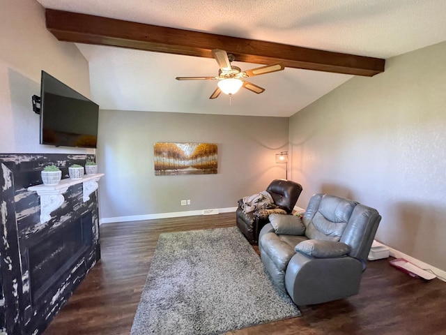 402 Range Rd, Springfield, MN 56087 - living area featuring beam ceiling, a ceiling fan, dark wood finished floors, and a fireplace