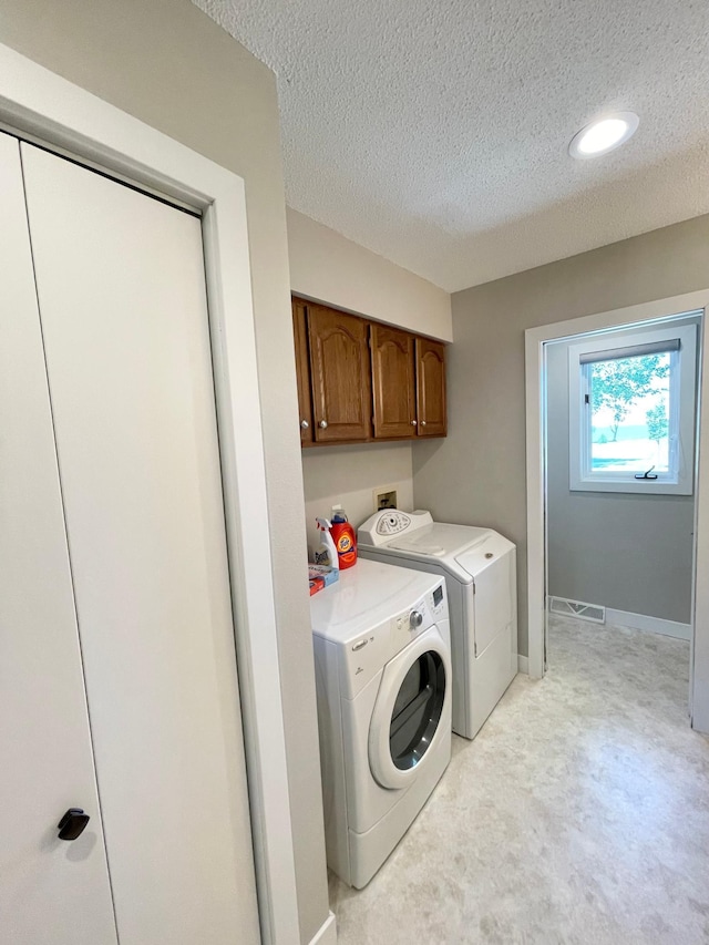 402 Range Rd, Springfield, MN 56087 - laundry room with cabinet space, washing machine and dryer, a textured ceiling, light colored carpet, and recessed lighting