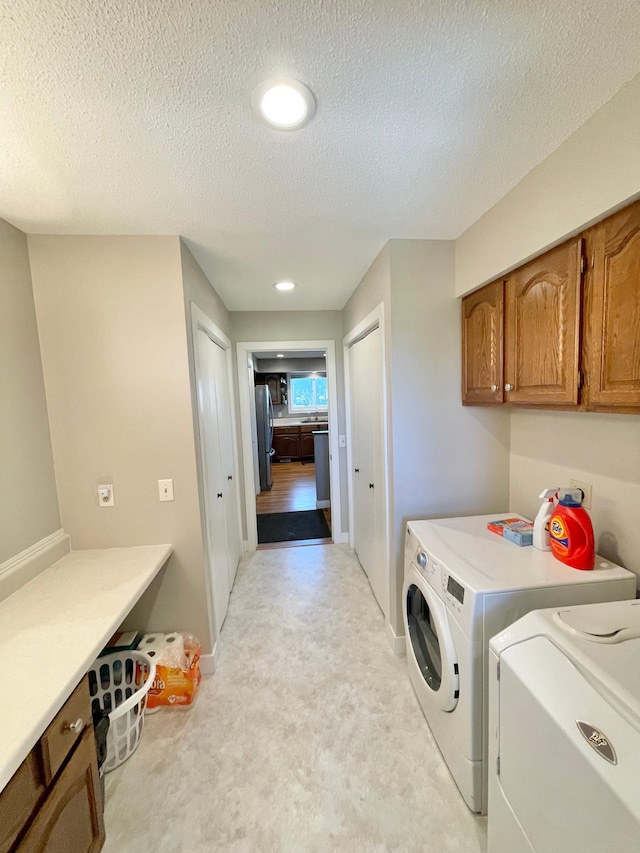 402 Range Rd, Springfield, MN 56087 - laundry room featuring washer and clothes dryer, cabinet space, a textured ceiling, light carpet, and recessed lighting