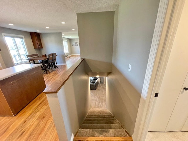 402 Range Rd, Springfield, MN 56087 - staircase featuring wood finished floors, recessed lighting, and a textured ceiling