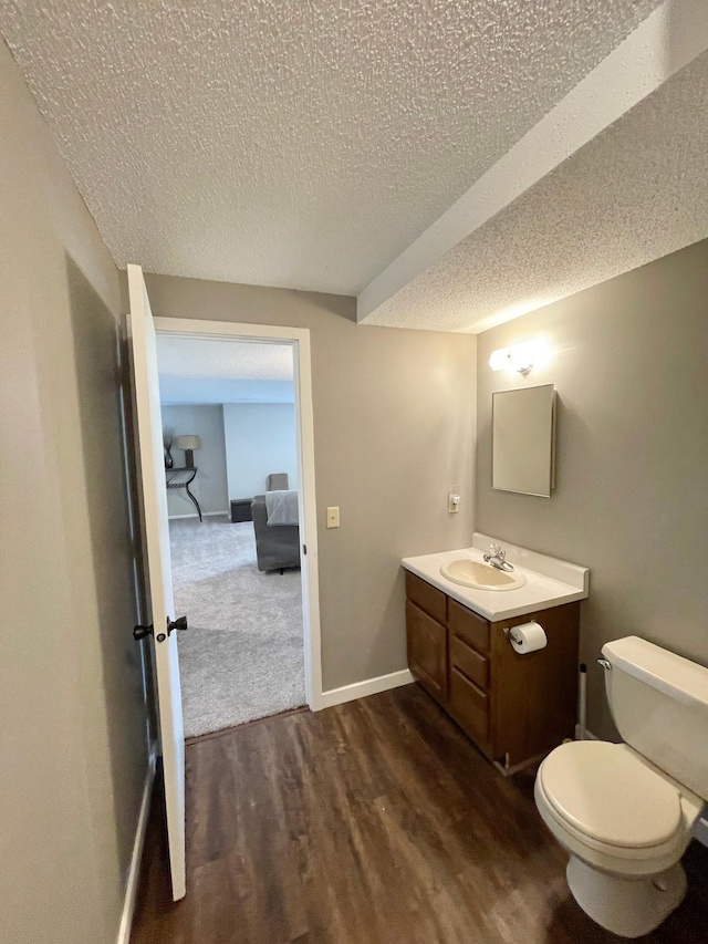 402 Range Rd, Springfield, MN 56087 - half bathroom featuring wood finished floors, vanity, and a textured ceiling