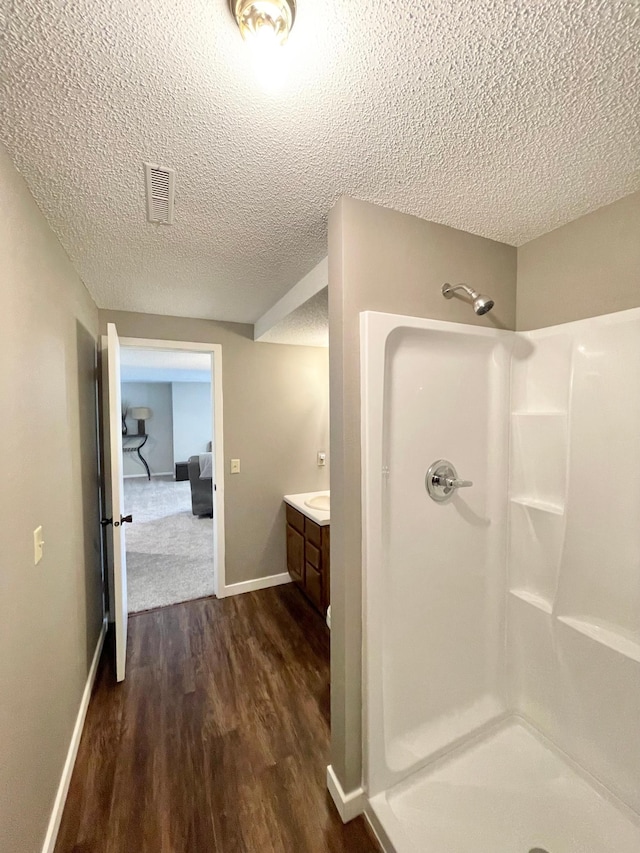 402 Range Rd, Springfield, MN 56087 - full bath featuring walk in shower, a textured ceiling, wood finished floors, and vanity