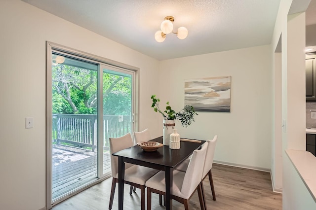 8222 Brandywine Pkwy, Brooklyn Park, MN 55444 - dining area with light wood finished floors and a chandelier
