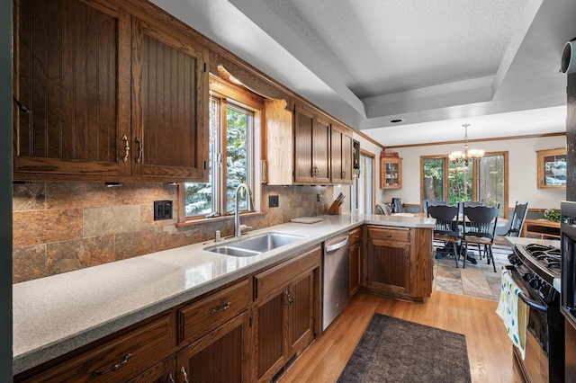 1322 Bidwell St, West Saint Paul, MN 55118 - kitchen with a chandelier, gas stove, a tray ceiling, dishwasher, and tasteful backsplash