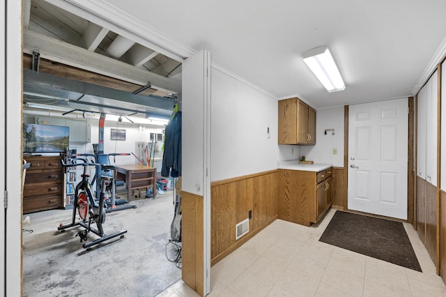 1322 Bidwell St, West Saint Paul, MN 55118 - below grade area with wooden walls, a wainscoted wall, and ornamental molding