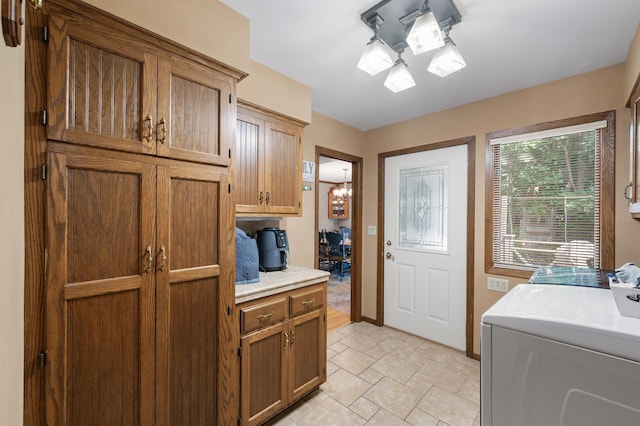 1322 Bidwell St, West Saint Paul, MN 55118 - laundry room with washer / dryer, cabinet space, and light stone finish flooring
