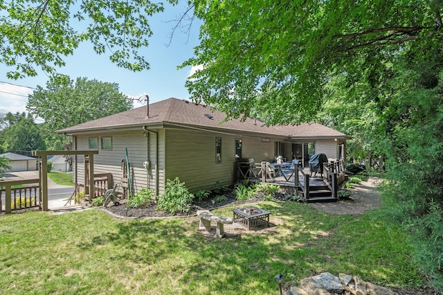 1322 Bidwell St, West Saint Paul, MN 55118 - rear view of house with an outdoor fire pit, a deck, and a lawn