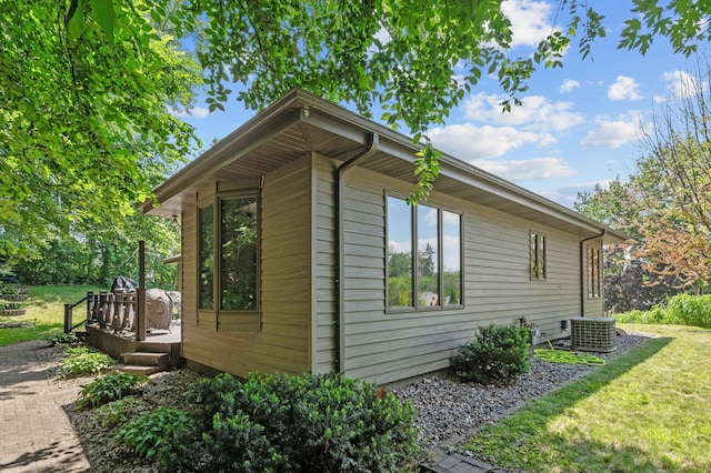 1322 Bidwell St, West Saint Paul, MN 55118 - view of side of home featuring a wooden deck and a lawn