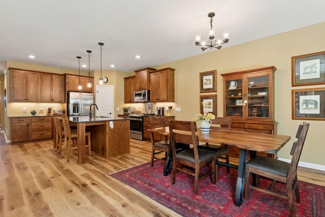 1101 Fabel Ln, Waconia, MN 55387 - dining area featuring light wood-style floors, a chandelier, and recessed lighting