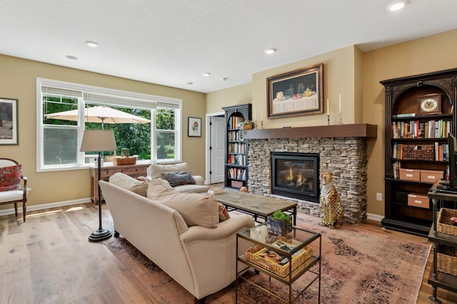 1101 Fabel Ln, Waconia, MN 55387 - living area featuring a fireplace, wood finished floors, a textured ceiling, and recessed lighting