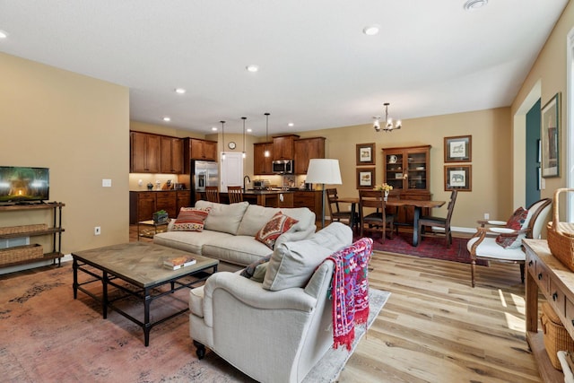 1101 Fabel Ln, Waconia, MN 55387 - living room with light wood-type flooring, a chandelier, and recessed lighting