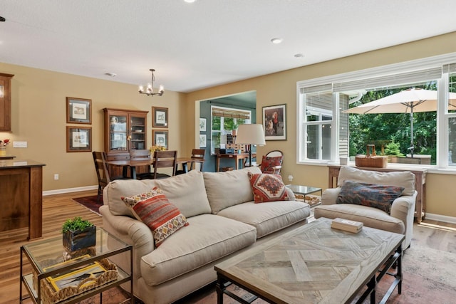 1101 Fabel Ln, Waconia, MN 55387 - living area with light wood-type flooring, healthy amount of natural light, and a chandelier