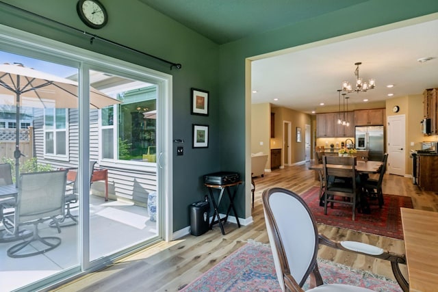 1101 Fabel Ln, Waconia, MN 55387 - dining space featuring light wood finished floors, a chandelier, healthy amount of natural light, and recessed lighting