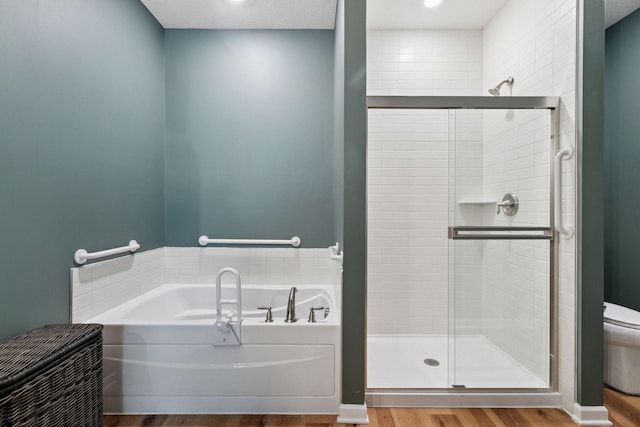 1101 Fabel Ln, Waconia, MN 55387 - bathroom with a garden tub, a shower stall, and wood finished floors