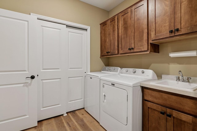 1101 Fabel Ln, Waconia, MN 55387 - washroom with washing machine and clothes dryer, cabinet space, and light wood-style floors