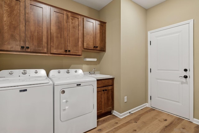 1101 Fabel Ln, Waconia, MN 55387 - laundry room with light wood-style flooring, separate washer and dryer, and cabinet space