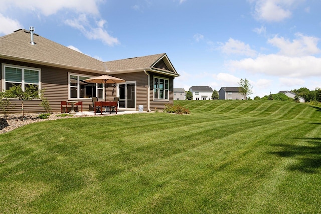1101 Fabel Ln, Waconia, MN 55387 - back of property with a patio area, a lawn, and roof with shingles