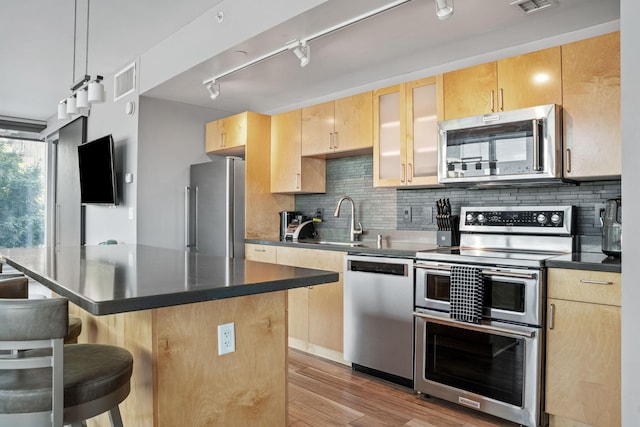 8151 33rd Ave S Unit 201, Bloomington, MN 55425 - kitchen featuring stainless steel appliances, light brown cabinets, and a breakfast bar