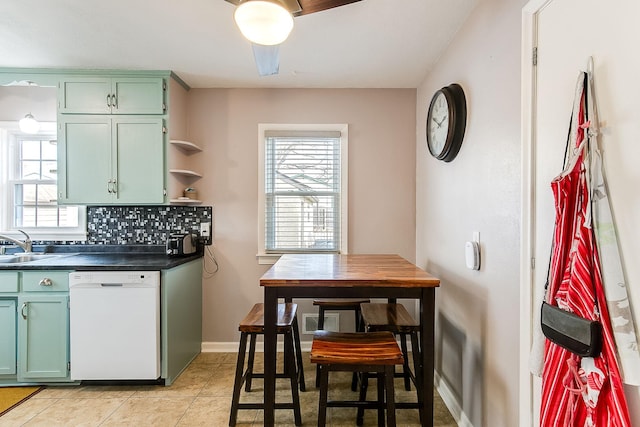 2074 Mcknight Rd N, North Saint Paul, MN 55109 - kitchen with white dishwasher, green cabinets, dark countertops, and healthy amount of natural light