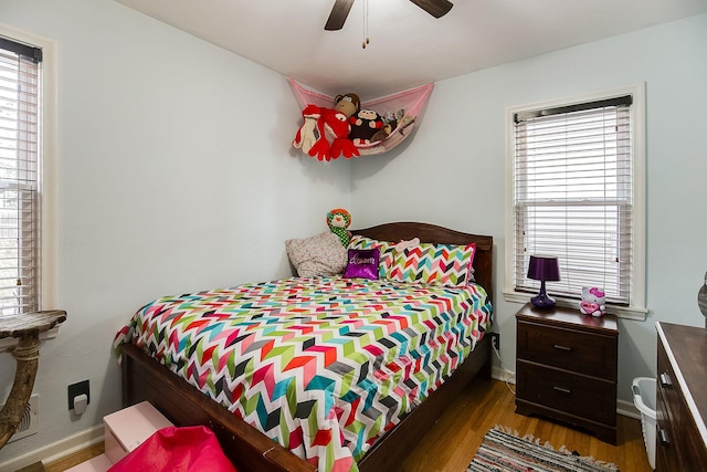 2074 Mcknight Rd N, North Saint Paul, MN 55109 - bedroom featuring multiple windows, wood finished floors, and ceiling fan