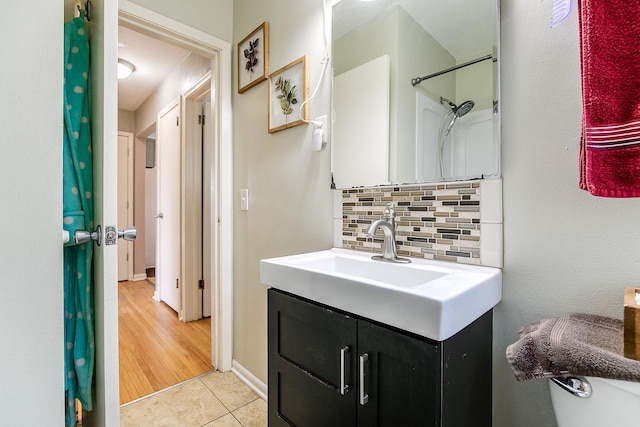 2074 Mcknight Rd N, North Saint Paul, MN 55109 - bathroom with backsplash, vanity, and tile patterned floors