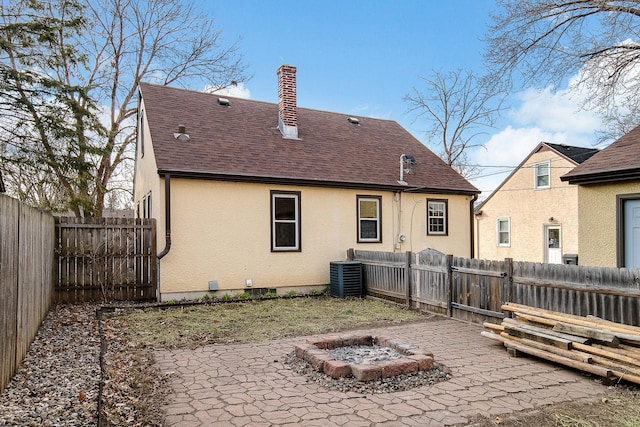 2074 Mcknight Rd N, North Saint Paul, MN 55109 - back of house featuring an outdoor fire pit, a patio, roof with shingles, and a fenced backyard