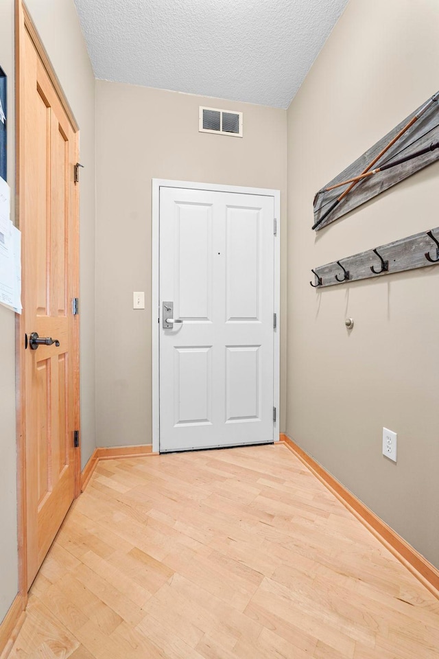 500 Grant St Unit 2109, Minneapolis, MN 55404 - doorway with light wood-style floors and a textured ceiling