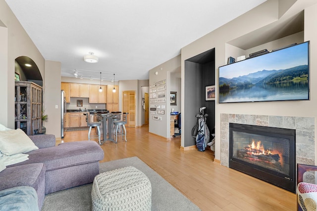 500 Grant St Unit 2109, Minneapolis, MN 55404 - living area featuring rail lighting, light wood-style flooring, and a tiled fireplace