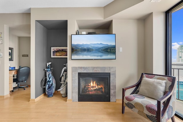 500 Grant St Unit 2109, Minneapolis, MN 55404 - living area featuring wood finished floors, a desk, and a fireplace