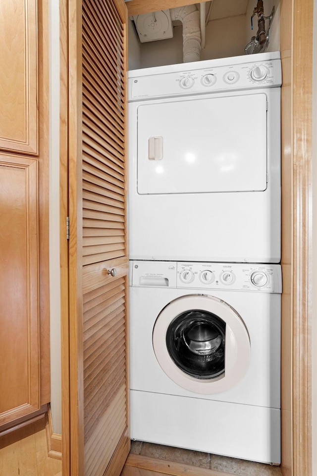 500 Grant St Unit 2109, Minneapolis, MN 55404 - washroom with stacked washer and clothes dryer and light wood finished floors
