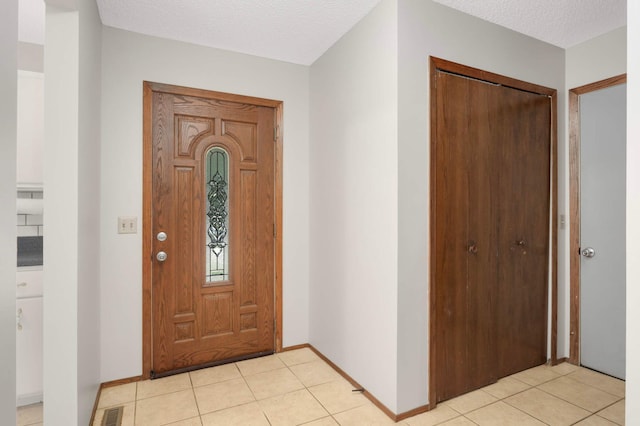 5698 Turtle Lake Rd, Shoreview, MN 55126 - entrance foyer featuring light tile patterned flooring and a textured ceiling