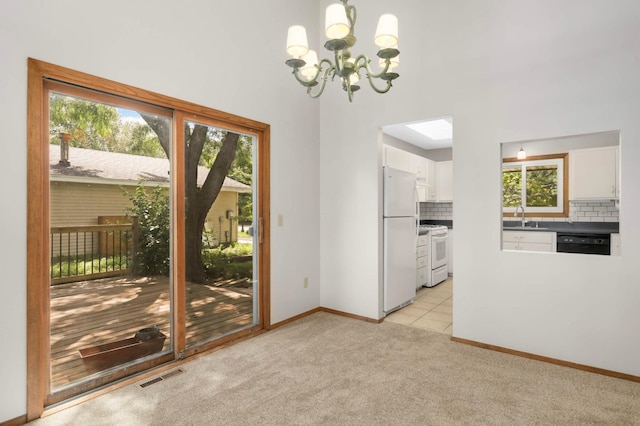5698 Turtle Lake Rd, Shoreview, MN 55126 - unfurnished dining area featuring a chandelier, plenty of natural light, light colored carpet, and a towering ceiling