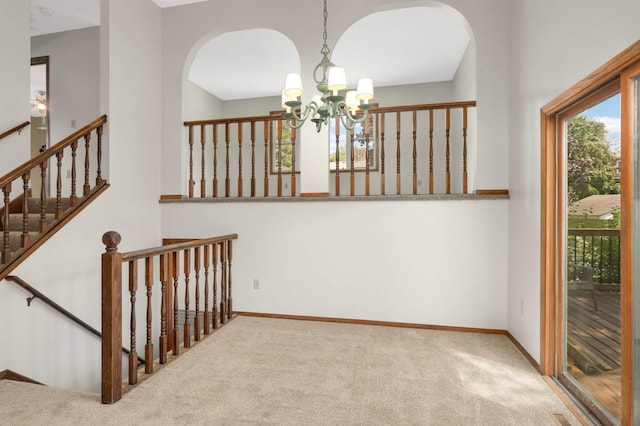 5698 Turtle Lake Rd, Shoreview, MN 55126 - stairway with carpet floors, a chandelier, and arched walkways