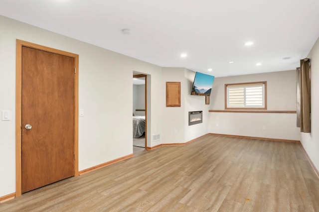 5698 Turtle Lake Rd, Shoreview, MN 55126 - unfurnished living room with light wood-style flooring and recessed lighting