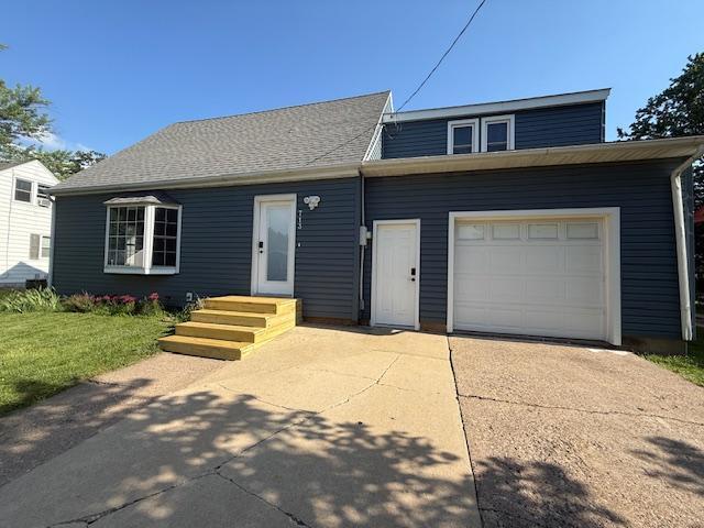 713 Grove St E, Caledonia, MN 55921 - view of front facade featuring concrete driveway and a garage
