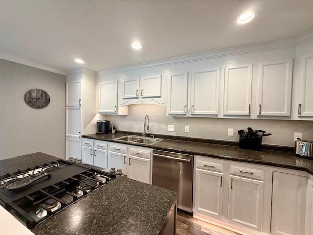 713 Grove St E, Caledonia, MN 55921 - kitchen featuring stainless steel appliances, white cabinetry, dark stone countertops, crown molding, and recessed lighting