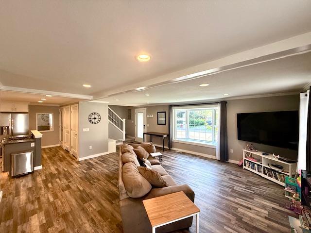 713 Grove St E, Caledonia, MN 55921 - living area with stairway, dark wood-style floors, recessed lighting, and ornamental molding
