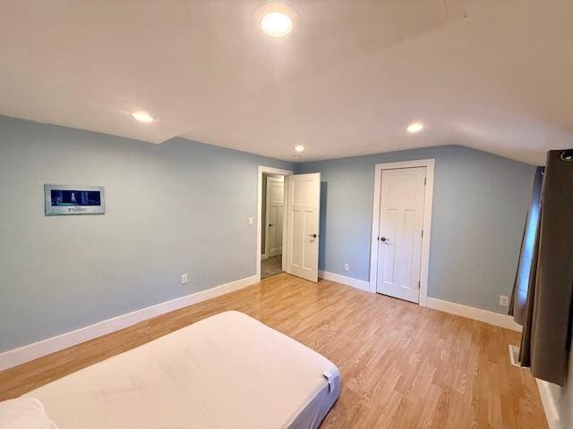 713 Grove St E, Caledonia, MN 55921 - bedroom with recessed lighting, light wood-style floors, and vaulted ceiling