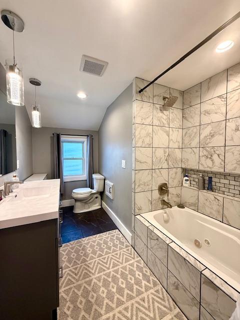 713 Grove St E, Caledonia, MN 55921 - full bath featuring vanity, lofted ceiling, tiled shower / bath combo, marble finish floors, and recessed lighting