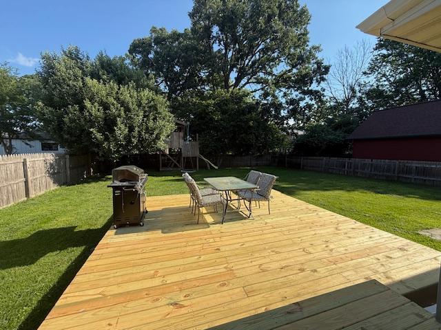 713 Grove St E, Caledonia, MN 55921 - wooden deck with grilling area, a fenced backyard, and outdoor dining space