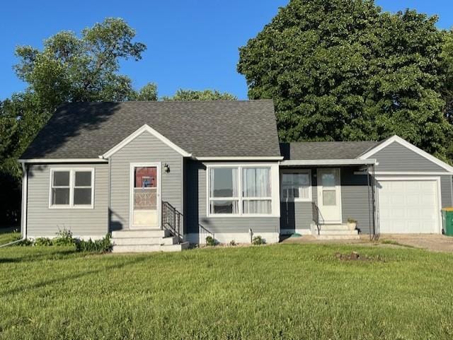 1017 Sibley Ave S, Litchfield, MN 55355 - view of front of property with entry steps, an attached garage, and a front lawn